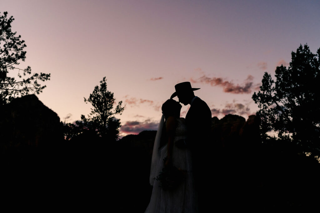 Cinematic wedding film still of a couple standing among the red rocks in Sedona, Arizona.